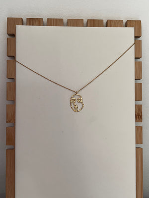 Gold “FACE” necklace